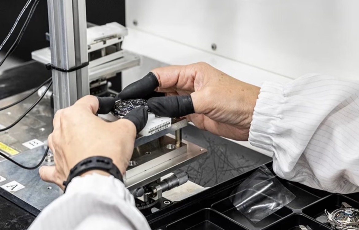 Watchmaker positioning a watch for precision testing